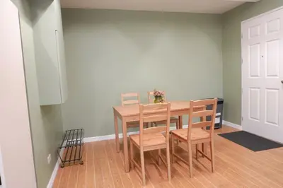 a dining room with a wooden table and chairs at ALTEAN Apartments - Lourdes Room in Manila