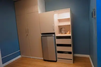 a small kitchen with a refrigerator in a room at ALTEAN Apartments - Lydia Room in Manila