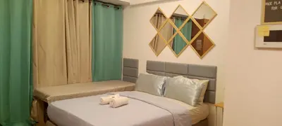 a bedroom with two beds with towels on them at Avah de lara condotel NAIA T3 in Manila