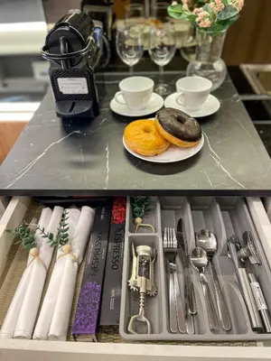 a drawer with two donuts and plates and silverware at SMDC Fame Residence luxurious family suite condo near mrt in Manila