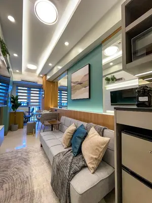 a living room with a couch and a table at SMDC Fame Residence luxurious family suite condo near mrt in Manila