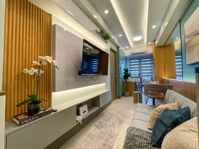 a living room with a couch and a tv at SMDC Fame Residence luxurious family suite condo near mrt in Manila