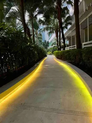 a street with yellow lights on the side of a building at Azure cozy corners in Manila