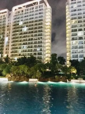 a large pool of water in front of two tall buildings at Azure Urban Resort a12 Wavepool near mall airport in Manila
