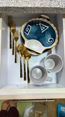 a drawer with utensils and a plate and spoon and fork at J Studio - Fast WiFi, 55