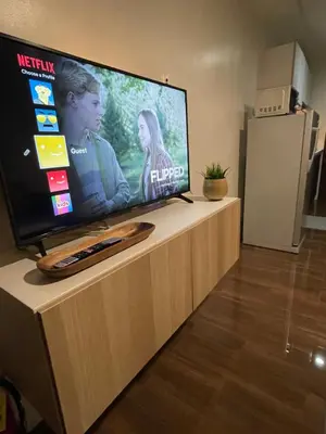 a flat screen tv sitting on top of a counter at Destina @Air Residences Makati, Metro Manila in Manila