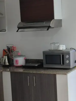 a kitchen counter with a microwave on a counter top at Experience OCEAN VIEW Rooms in The Heart Of Manila, Enjoy FREE ACCESS To The POOL, SAUNA, PLUS MASSAGE PROMO In Prime Location Near The US Embassy, NAIA, Makati, BGC, Mall of Asia, And Chinatown This Is A Limited-Time Offer, Book Now in Manila