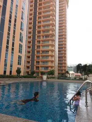 two children playing in a swimming pool in a city at Venice Luxury Residences, Tower B, McKinley Hill, Taguig in Manila