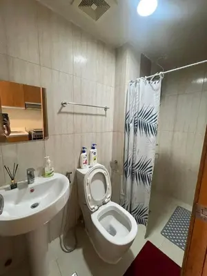 a bathroom with a toilet and a sink and a shower at Manila Bay Views City Delights Stay near St Lukes and US Embassy in Ermita Manila in Manila
