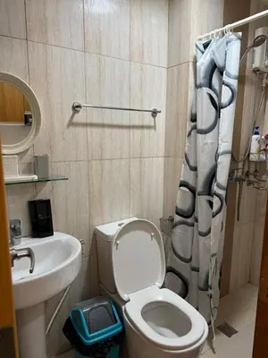 a small bathroom with a toilet and a sink at Manila Bay Views City Delights Stay near St Lukes and US Embassy in Ermita Manila in Manila
