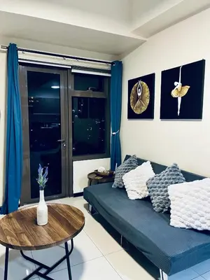 a living room with a couch and a table at Sundawn RadianceManilaBay in Manila