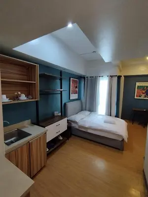 a bedroom with a bed and a sink in it at Yuanhang 1508 in Manila