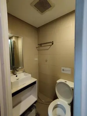 a bathroom with a white toilet and a sink at Yuanhang 1508 in Manila