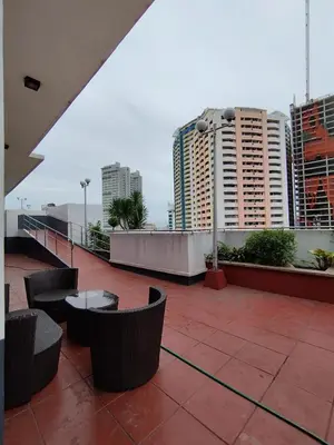 a balcony with tables and chairs and buildings at Yuanhang 1508 in Manila