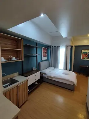 a bedroom with a bed and a sink in it at Yuanhang 1508 in Manila