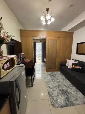 a kitchen and living room with a couch and a table at JAL's Cozy Haven in Manila