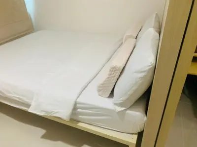 a bunk bed with white sheets and pillows on it at SMDC Light Residences Condominium in Manila