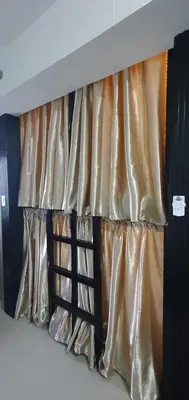 a bed with gold and black curtains in a room at C Place - Capsule B - Upper in Manila