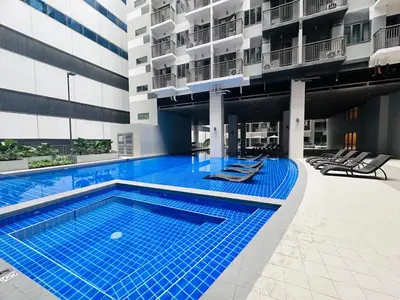 a swimming pool in the middle of a building at Serendipity Suite at S Residences in Manila