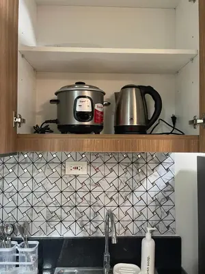 a pot and a toaster on a shelf in a kitchen at Molly Shore Getaway Unit 1277 in Manila