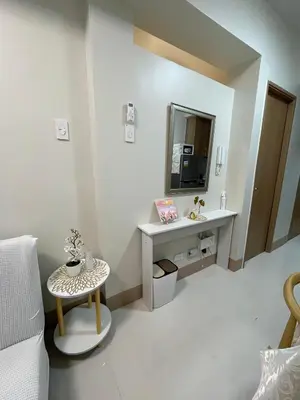 a white bathroom with a sink and a mirror at Molly Shore Getaway Unit 1277 in Manila