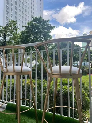 two chairs sitting on top of a balcony at Luxury lodgings by PN Leonardo in Manila