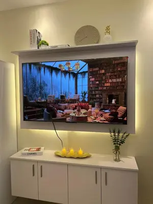 a large tv hanging on a wall in a room at Luxury lodgings by PN Leonardo in Manila