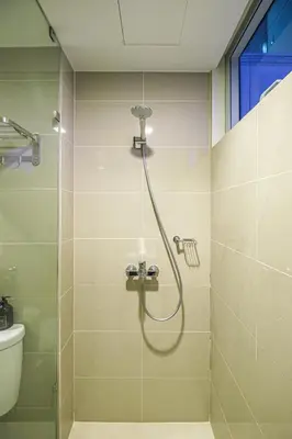a shower in a bathroom with a glass door at Premium 3BR Suite UptownBGC w/ Bathtub & Balcony in Manila