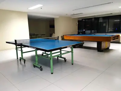 two ping pong tables sitting in a room with sidx sidx at HOYA Aparthotel In Malate in Manila