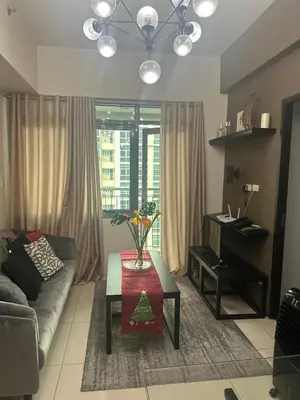 a living room with a couch and a table at Condo in BGC near Grand Hyatt Hotel in Manila