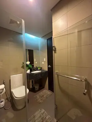 a bathroom with a toilet and a sink at Condo in BGC near Grand Hyatt Hotel in Manila