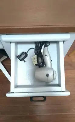 a hair dryer in a white box under a desk at 2A2J Apartments - 2 Bedroom in Manila