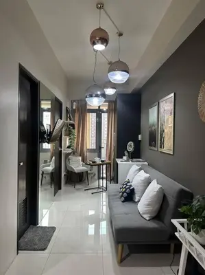 a living room with a couch and a table at Condo in BGC near Grand Hyatt in Manila