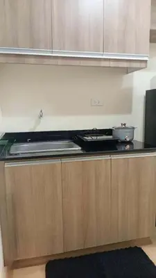 a kitchen with a stove and a counter top at Coho The Hermosa - Staycation Studio Unit and Balcony View with Swimming Pool and Open Court access in Manila