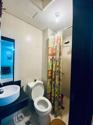 a bathroom with a toilet and a sink and a shower at Condo in Metro Manila V PAD in Manila