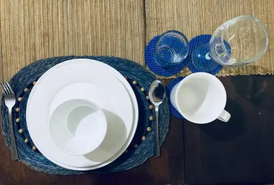 a table with two plates and cups on a table at Condo in Metro Manila V PAD in Manila