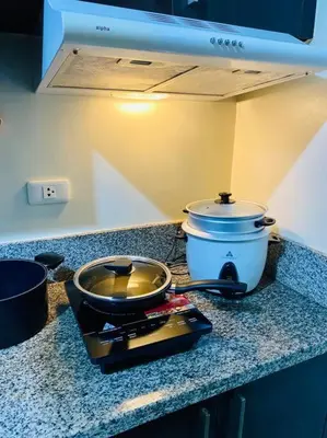 a kitchen counter with a pot and a slow cooker at Condo in Metro Manila V PAD in Manila