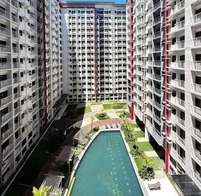 an overhead view of a pool in between two tall buildings at Paranaque Manila Bloom residences in Manila