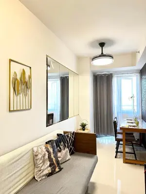 a living room with a couch and a table at Mall of Asia MOA S Residences , IKEA Pasay , NAIA Airport , Manila Bay in Manila