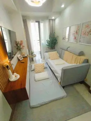a small living room with a couch and a table at Condo near MOA Pasay and NAIA Manila Airport in Manila
