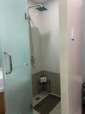 a shower with a glass door in a bathroom at Milia Condo w/ Free use of Swimming pool & Gym in Manila