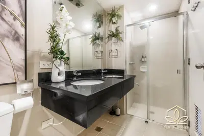 a bathroom with a black sink and a shower at Tropical Oasis w/ the best view of BGC + Netflix in Manila