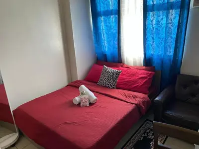 a small bed with two stuffed animals sitting on it at pierrecondotel in Manila