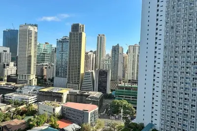 a view of a city skyline with tall buildings at Meowcation Condo in Makati in Manila