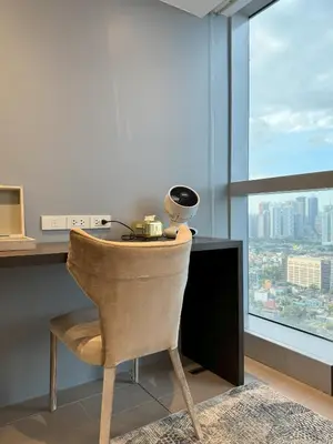a desk with a chair in a room with a window at Stylish 2br with View at BGC Uptown Parksuites 29a in Manila