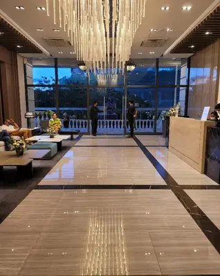a lobby with a large chandelier in a building at Stylish 2br with View at BGC Uptown Parksuites 29a in Manila