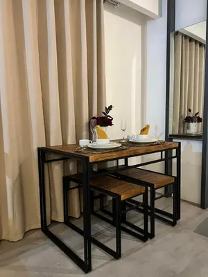 a dining room table with two chairs and a table and a table at Comfty, Chic & Spacious Room with Parking & WiFi in Manila