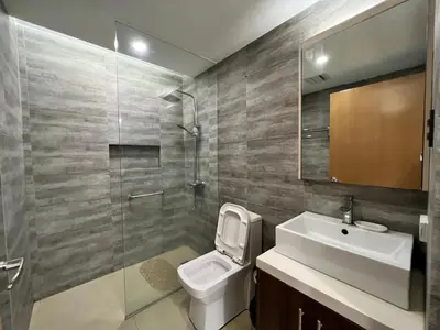 a bathroom with a toilet and a sink and a shower at Comfty, Chic & Spacious Room with Parking & WiFi in Manila