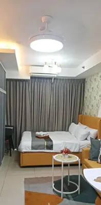 a hotel room with two beds and a table at Shell Residences by Amonbrey Suite nr airport in Manila