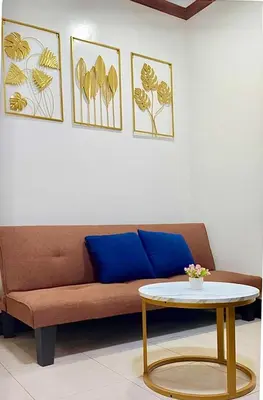 a living room with a couch and a table at Makati Transient Condo 3BR with Balcony, Wifi in Manila